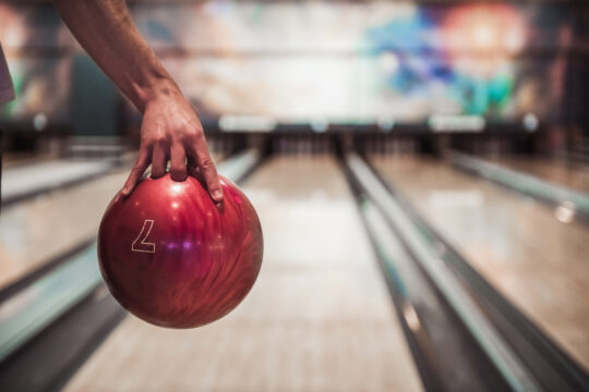 Man’s,Hand,Holding,A,Red,Bowling,Ball,Ready,To,Throw